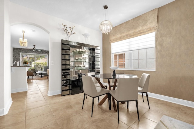 7416 Soiree Way, Reunion, FL 34747 - dining room featuring a chandelier, arched walkways, and tile patterned flooring