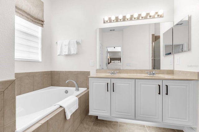 7416 Soiree Way, Reunion, FL 34747 - full bathroom featuring double vanity, a garden tub, connected bathroom, and tile patterned floors