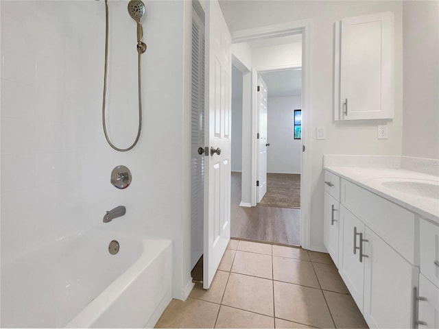 bathroom featuring tile patterned floors, tiled shower / bath combo, and vanity