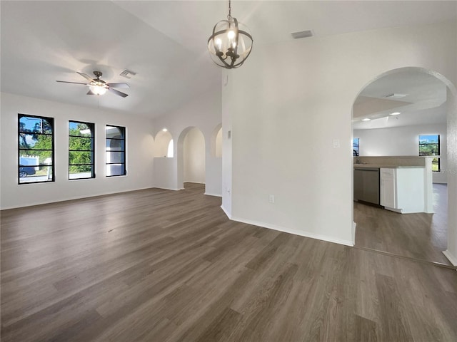 unfurnished living room with dark hardwood / wood-style flooring and ceiling fan with notable chandelier