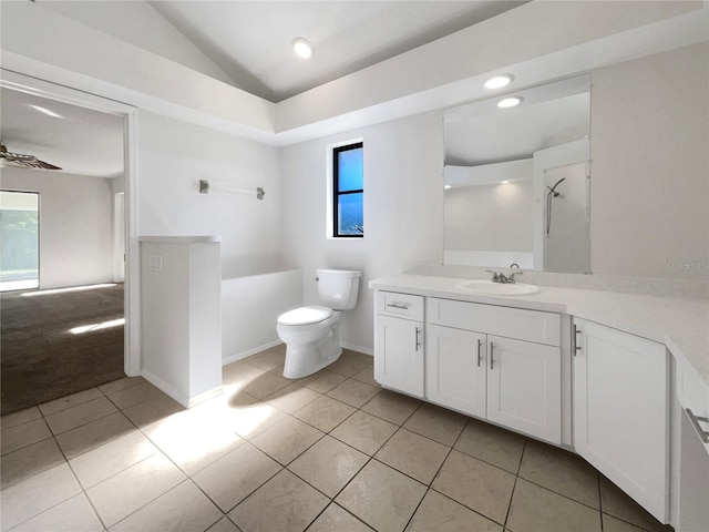 bathroom featuring toilet, tile patterned floors, ceiling fan, and a healthy amount of sunlight