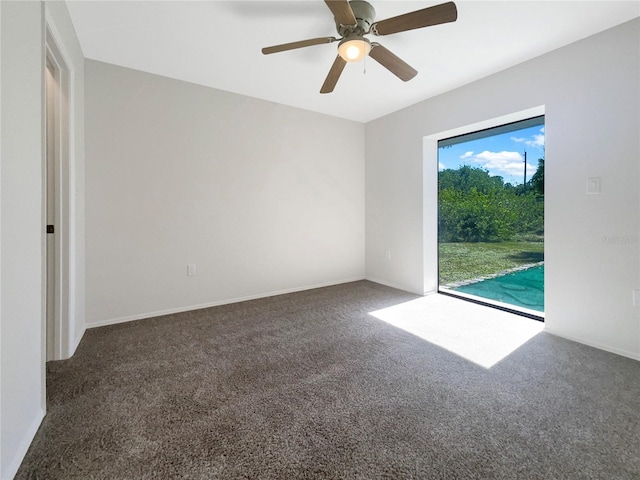 carpeted spare room with ceiling fan