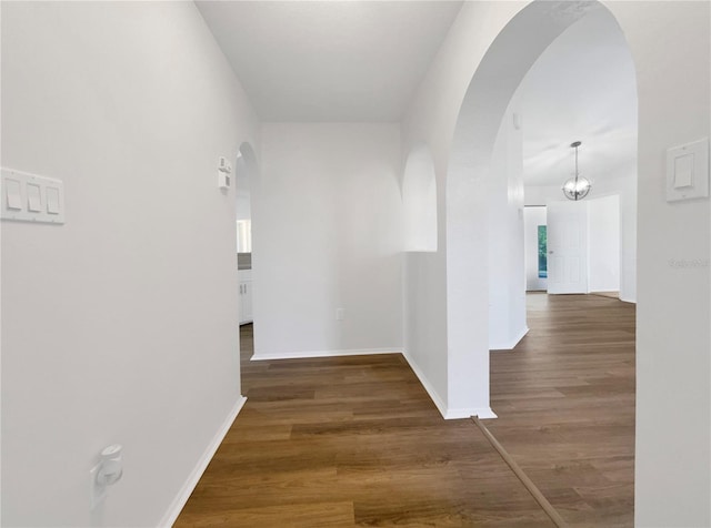 corridor with dark hardwood / wood-style floors