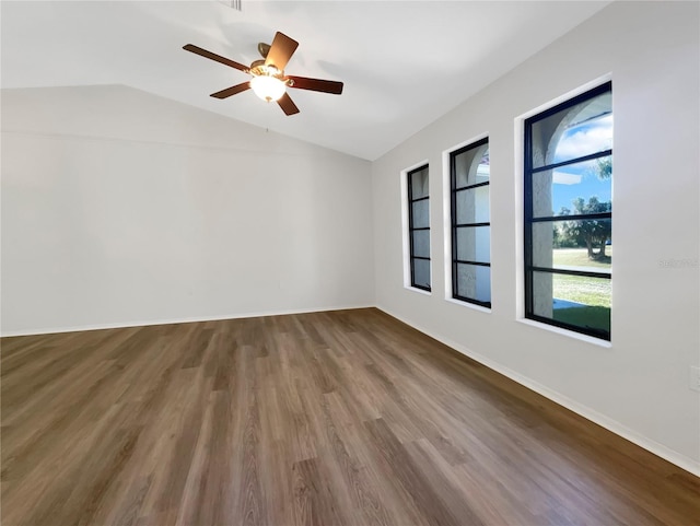 empty room featuring wood-type flooring, vaulted ceiling, and ceiling fan