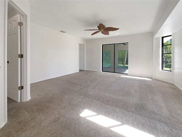 carpeted empty room featuring ceiling fan