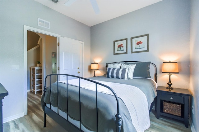 bedroom with ceiling fan and wood-type flooring