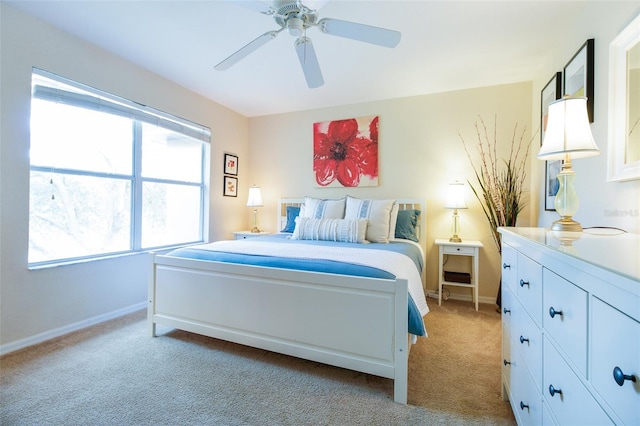 bedroom with ceiling fan and light carpet