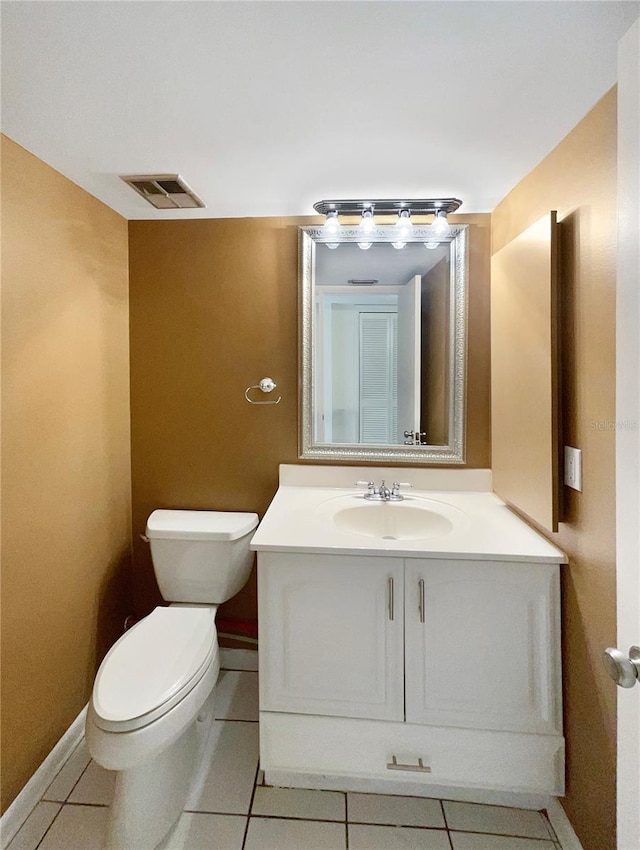 bathroom featuring tile patterned flooring, vanity, and toilet