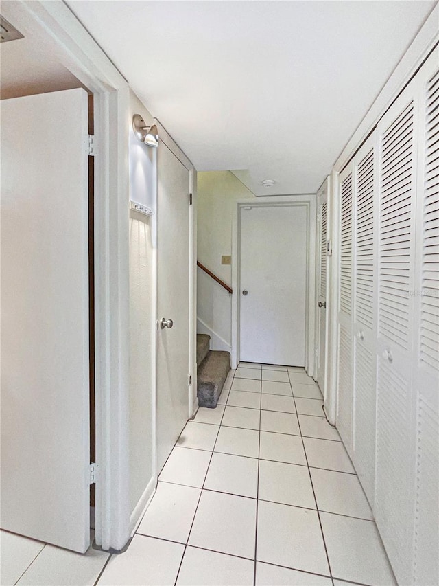 hall with light tile patterned floors