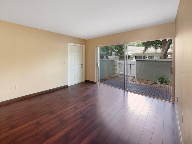 spare room with dark wood-type flooring