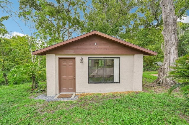 view of outbuilding with a yard