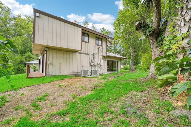 rear view of property with central AC unit