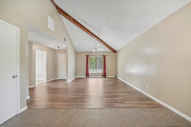 empty room featuring ceiling fan, wood-type flooring, high vaulted ceiling, and beam ceiling