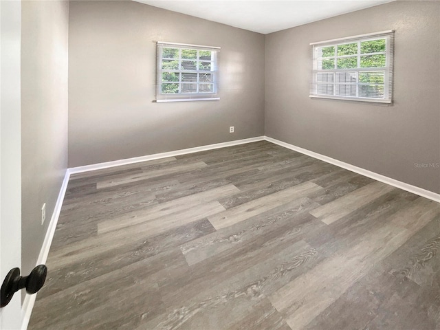 spare room featuring dark wood-type flooring