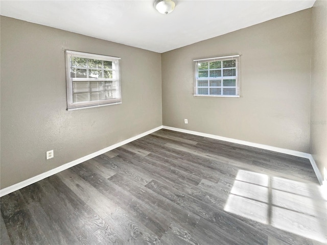 spare room with dark hardwood / wood-style flooring