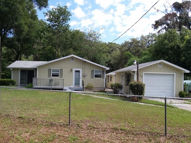 view of front of home featuring a front yard and a garage