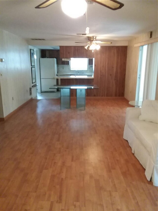 kitchen with white refrigerator, hardwood / wood-style floors, and ceiling fan