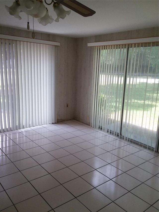 tiled empty room with ceiling fan