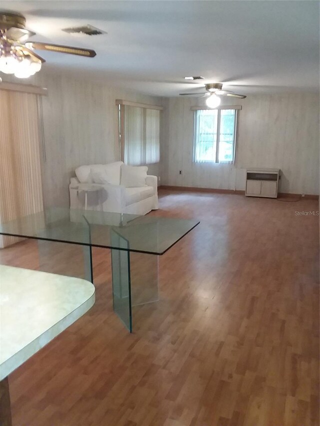 interior space with ceiling fan and wood-type flooring