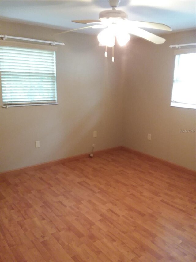 unfurnished room with ceiling fan and wood-type flooring