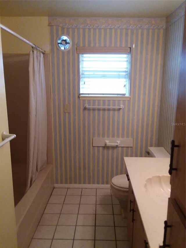 full bathroom with tile patterned flooring, vanity, toilet, and shower / bath combo