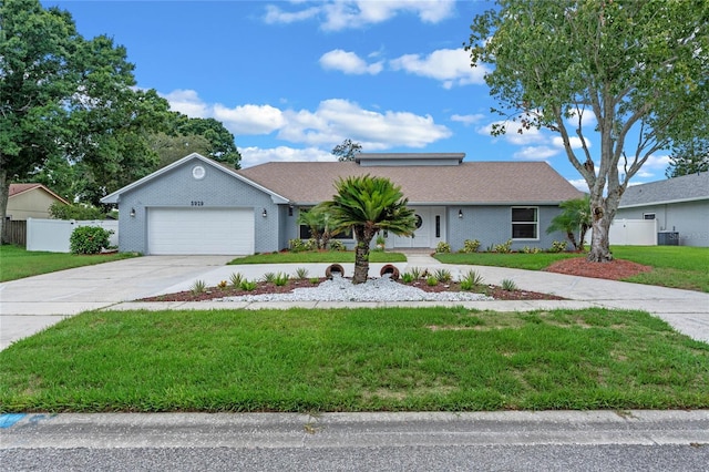 single story home with a front yard and a garage