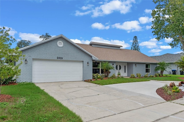 ranch-style house featuring a garage and a front yard