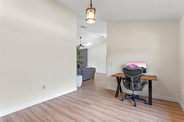 office space with ceiling fan, light hardwood / wood-style flooring, and vaulted ceiling