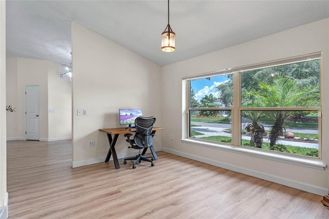 office area with vaulted ceiling and light hardwood / wood-style flooring