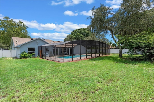 view of yard featuring glass enclosure and a fenced in pool