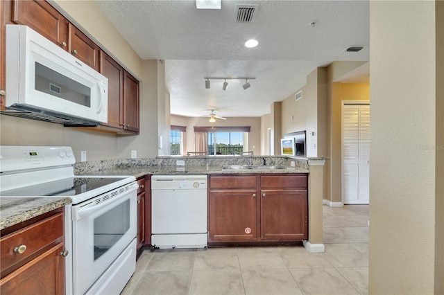 kitchen featuring white appliances, light tile patterned floors, a textured ceiling, ceiling fan, and track lighting