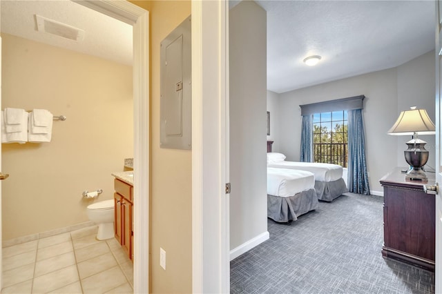 tiled bedroom featuring electric panel