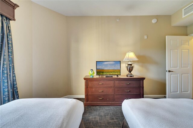 8801 Worldquest Blvd Unit 4406, Orlando, FL 32821 - bedroom featuring baseboards, visible vents, and dark carpet