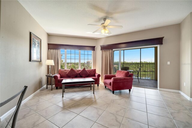 tiled living room featuring ceiling fan