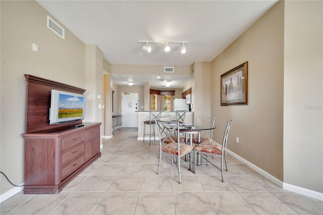 8801 Worldquest Blvd Unit 4406, Orlando, FL 32821 - dining area featuring baseboards, visible vents, a textured ceiling, and light tile patterned floors