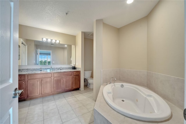 bathroom featuring dual vanity, tile patterned floors, toilet, and a textured ceiling