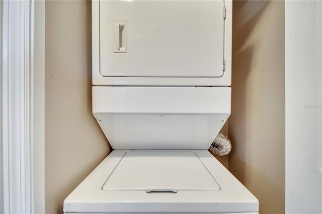 washroom featuring stacked washer / dryer