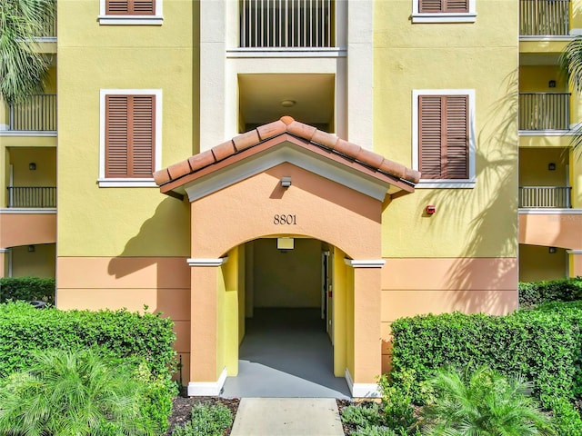 8801 Worldquest Blvd Unit 4406, Orlando, FL 32821 - property entrance featuring a tile roof, stucco siding, and an attached garage