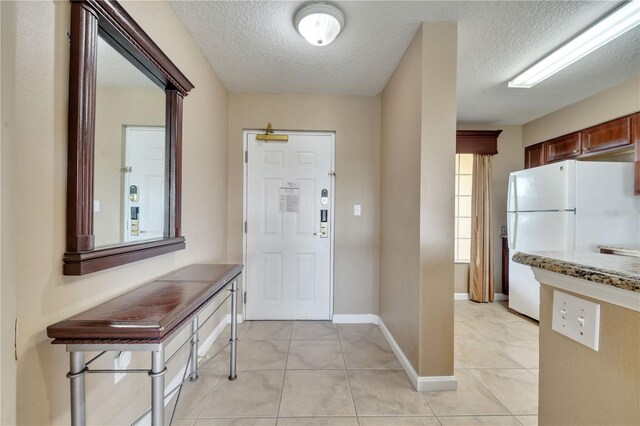 8801 Worldquest Blvd Unit 4406, Orlando, FL 32821 - foyer featuring light tile patterned floors, baseboards, and a textured ceiling