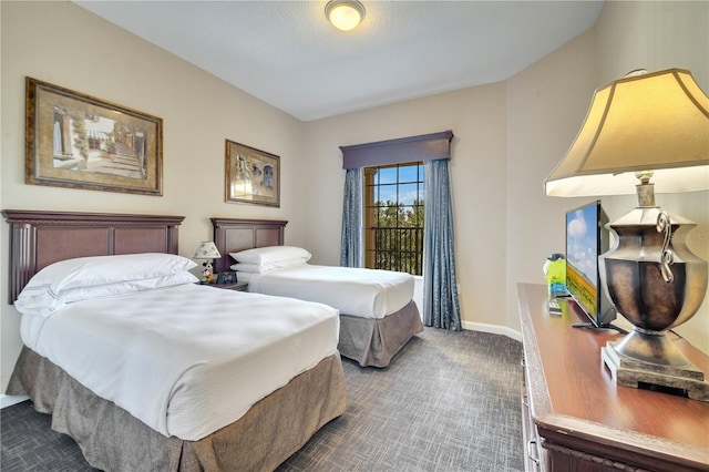 8801 Worldquest Blvd Unit 4406, Orlando, FL 32821 - bedroom with baseboards and dark carpet