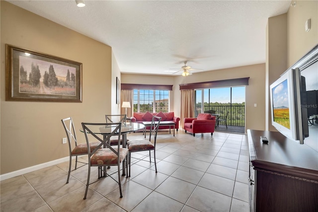 8801 Worldquest Blvd Unit 4406, Orlando, FL 32821 - dining space featuring light tile patterned floors, a textured ceiling, baseboards, and ceiling fan