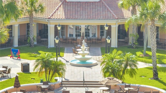 8801 Worldquest Blvd Unit 4406, Orlando, FL 32821 - back of house with fence, a lawn, a tile roof, and a patio