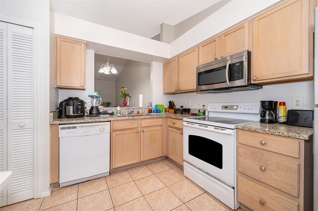 kitchen with white appliances, sink, light brown cabinetry, light tile patterned flooring, and a chandelier