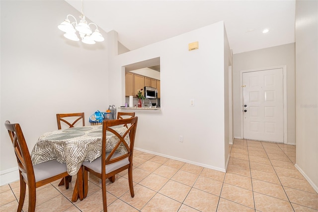 tiled dining room featuring an inviting chandelier