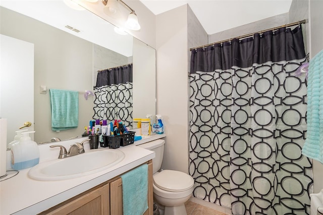 bathroom featuring tile patterned flooring, vanity, curtained shower, and toilet