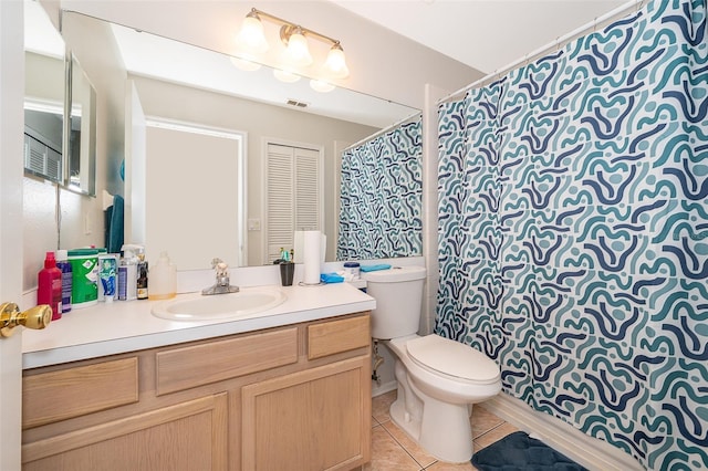 bathroom featuring tile patterned flooring, vanity, and toilet