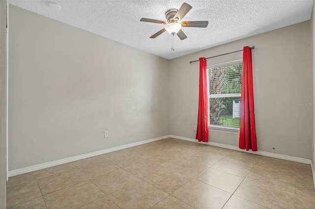 unfurnished room featuring a textured ceiling, ceiling fan, and light tile floors