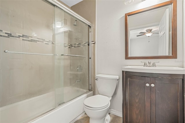 full bathroom featuring ceiling fan, enclosed tub / shower combo, tile floors, toilet, and large vanity