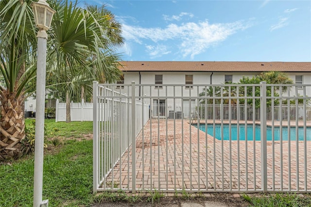 pool featuring a patio and fence