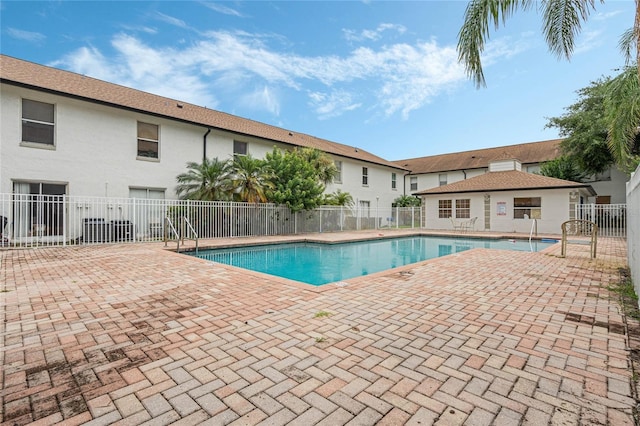 pool featuring a patio area and fence